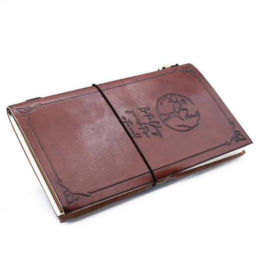 Slim brown handmade leather journal with an embossed Be the Change quote design and a wrap-around leather tie closure.