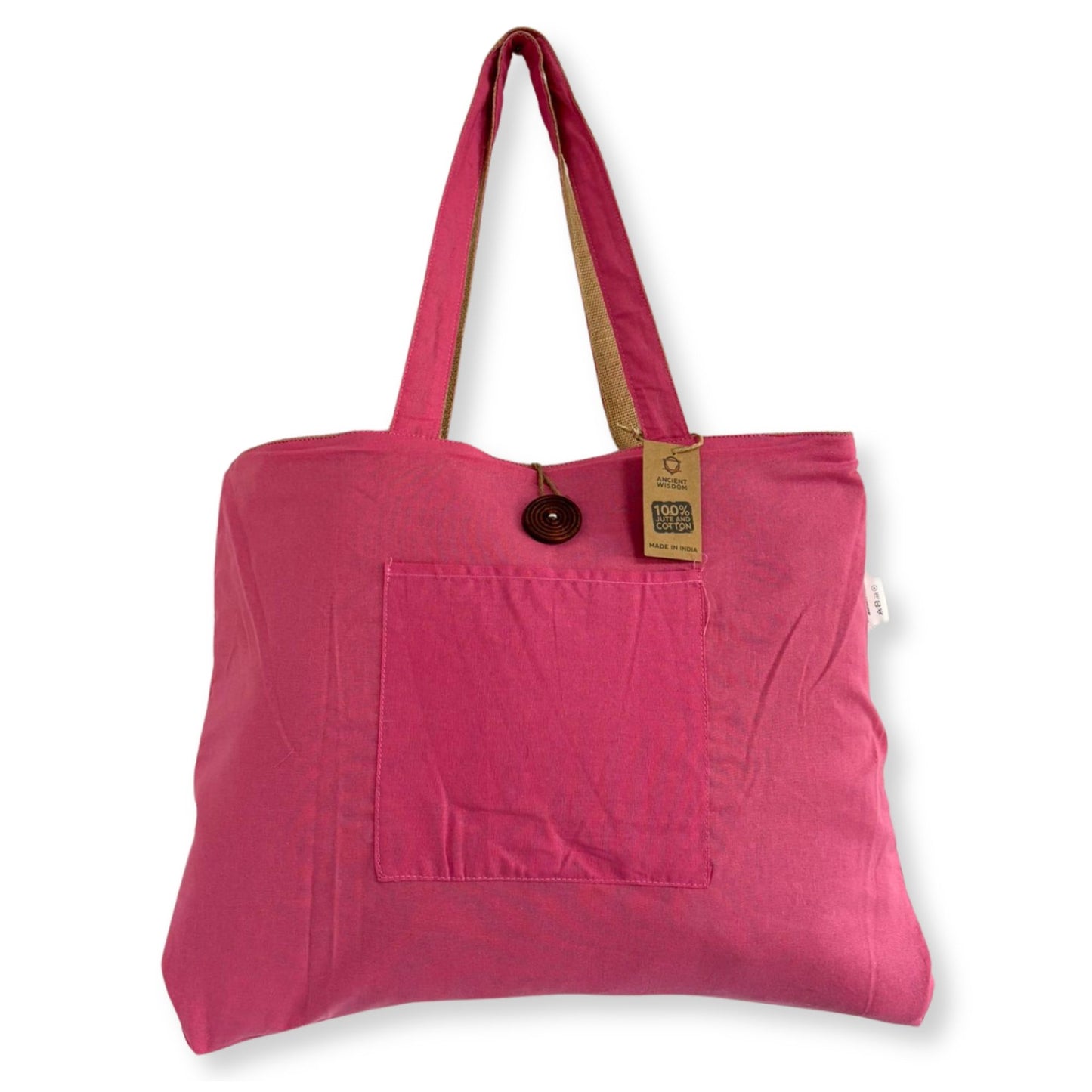 Large reversible pink tote bag made from woven jute and soft cotton with sturdy handles.