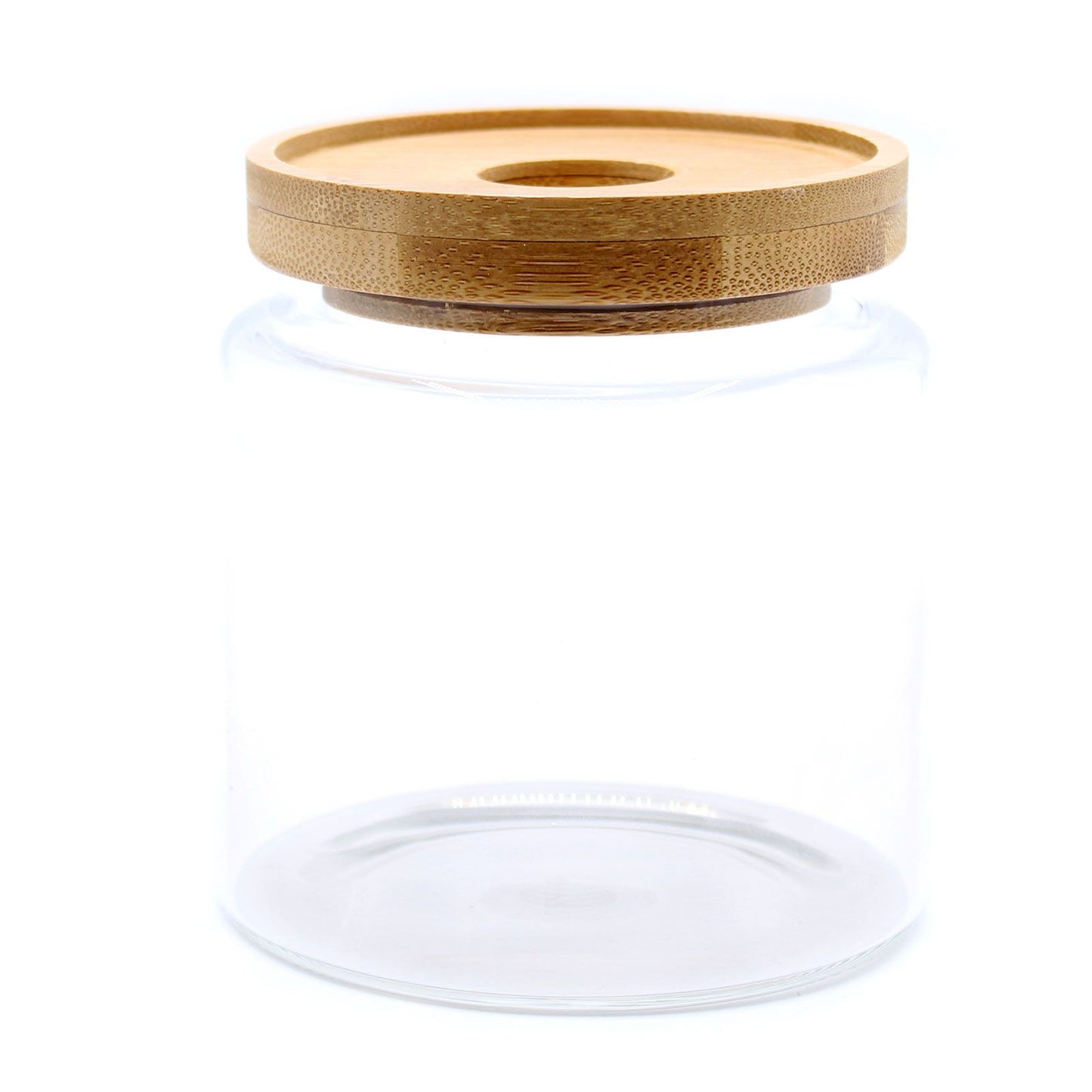 Clear glass storage jar with a natural bamboo lid and airtight seal on a minimalist background.