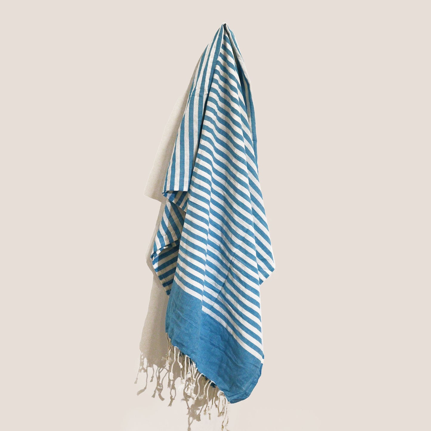 Handcrafted sky blue cotton pareo throw with a soft textured weave and delicate fringed edges.