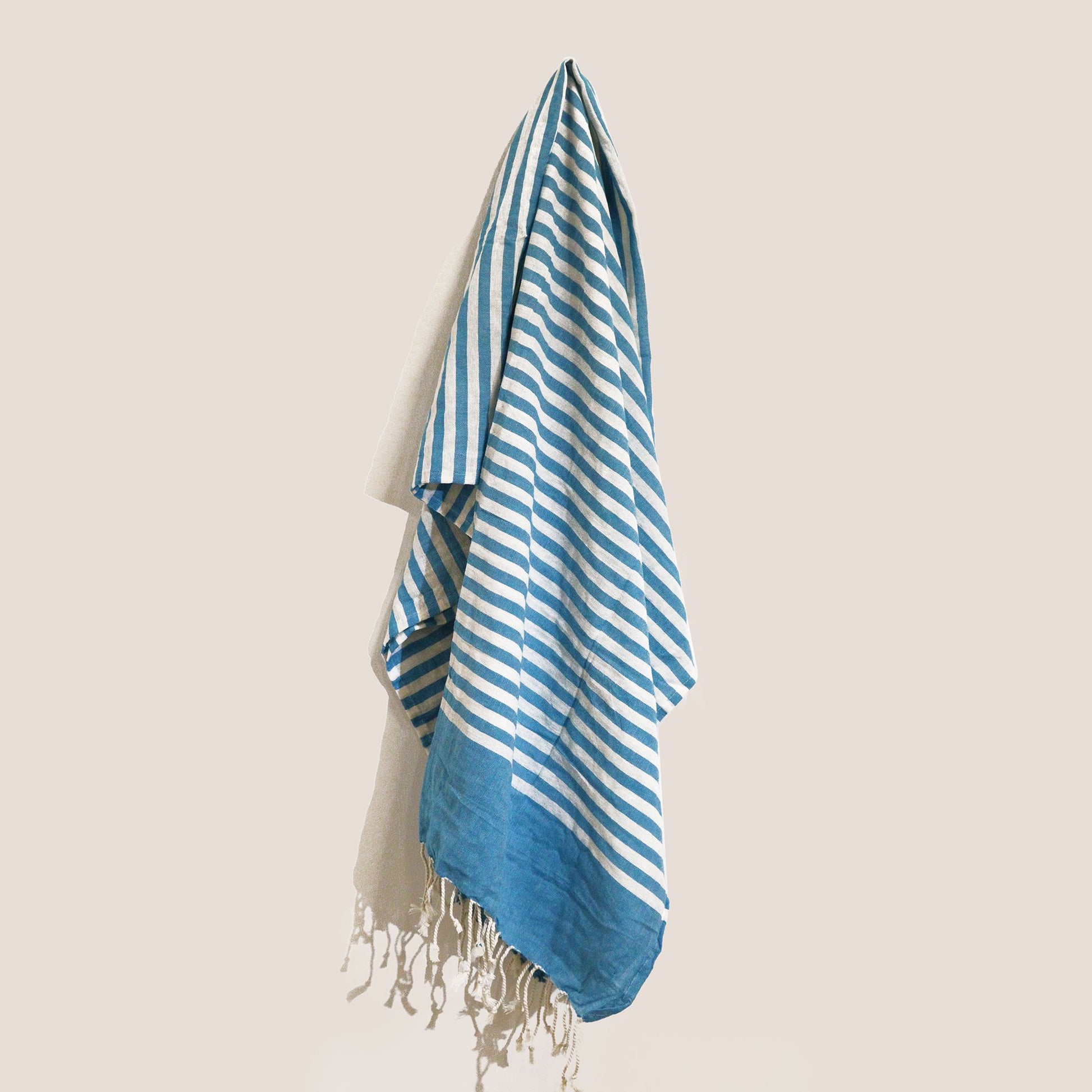 Handcrafted sky blue cotton pareo throw with a soft textured weave and delicate fringed edges.