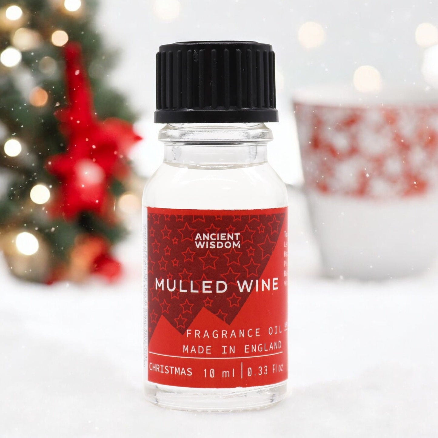 Small amber glass bottle of mulled wine fragrance oil featuring notes of orange, lemon, and warm woody undertones.