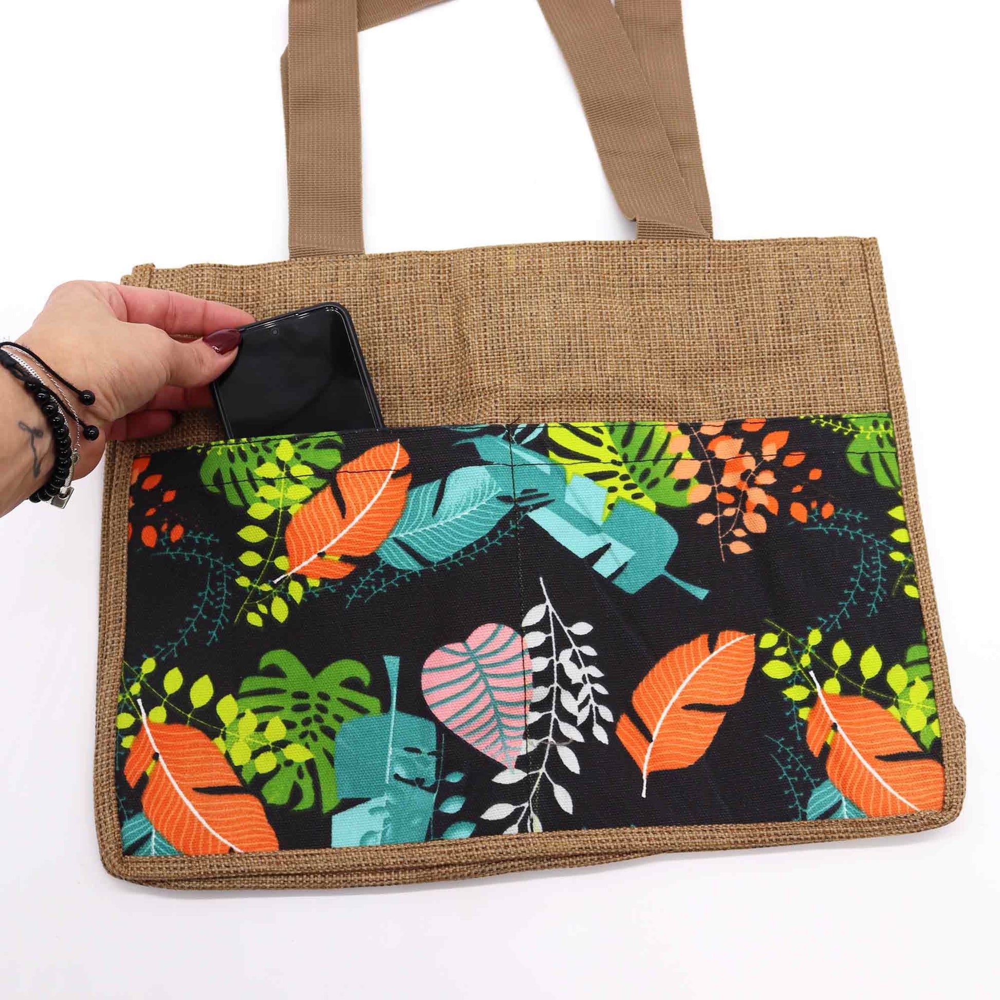 Colourful handcrafted fabric shopping bag with tropical patterns and sturdy shoulder straps.