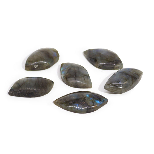 Hand-carved Labradorite gemstone in the shape of a leaf showing iridescent blue and green flashes.