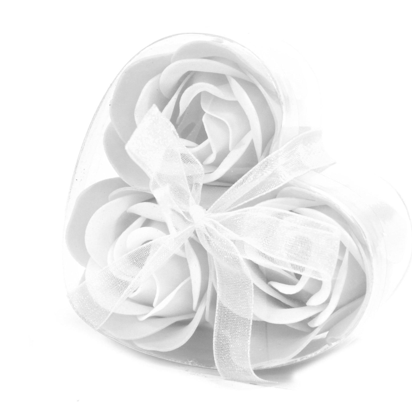 Three delicate white soap roses presented in a heart-shaped gift box.