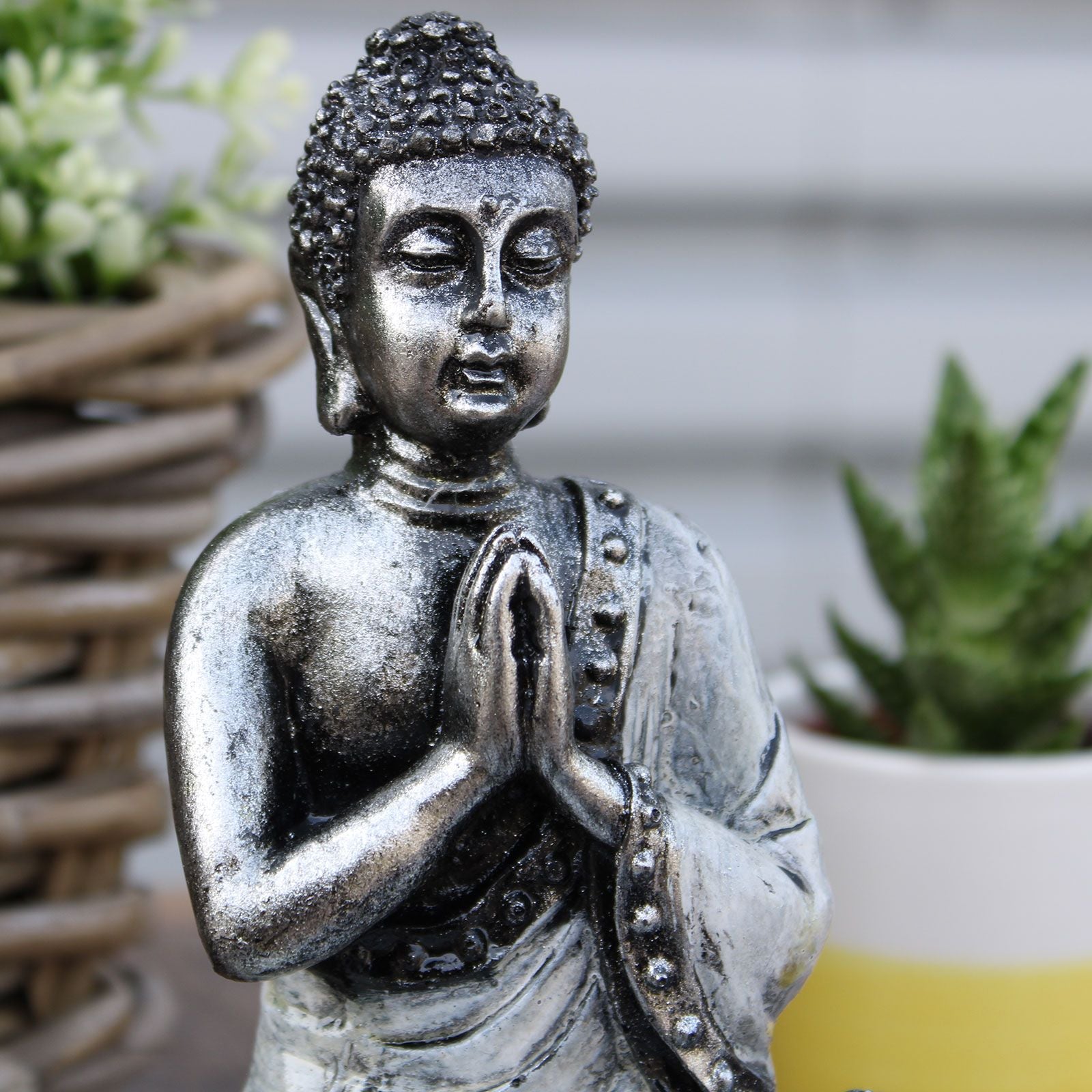 Medium sized resin Buddha figure with traditional robes in a striking red and metallic gold finish.
