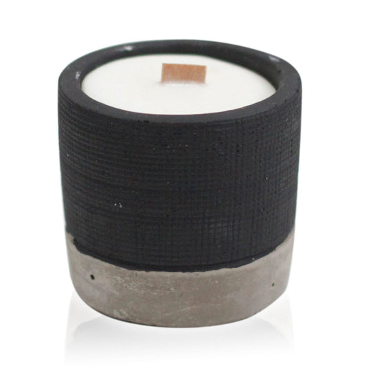 Minimalist black concrete pot candle with a natural wooden wick and smooth wax finish.