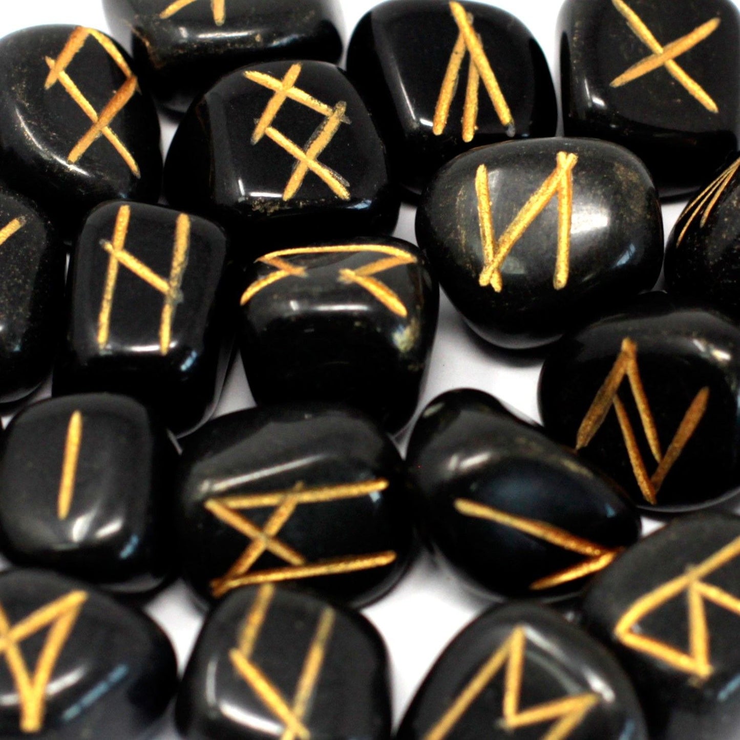 Set of polished black agate stones engraved with gold rune symbols, displayed alongside a black drawstring storage pouch.