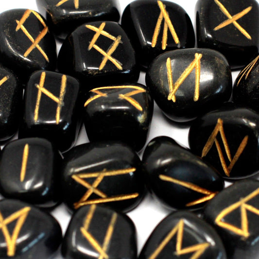 Set of polished black agate stones engraved with gold rune symbols, displayed alongside a black drawstring storage pouch.