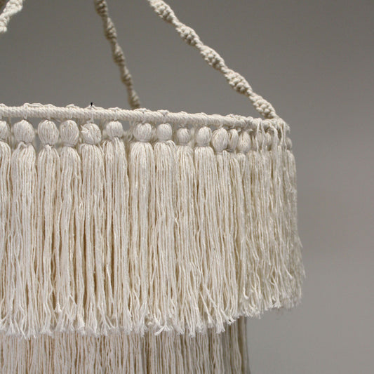 Hand-woven natural cream macrame chandelier with intricate boho-style knotting and long fringed tassels.