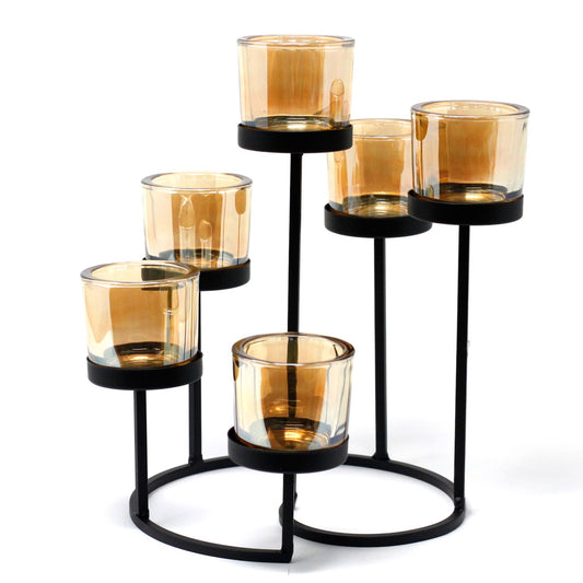Elegant black iron votive candle holder featuring a circular tree design with six glass cups for tea lights.