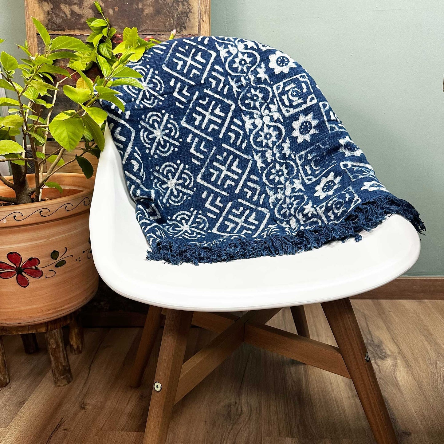 Close-up of a handmade indigo cotton throw with a sleek white and blue Desi Stripes pattern.