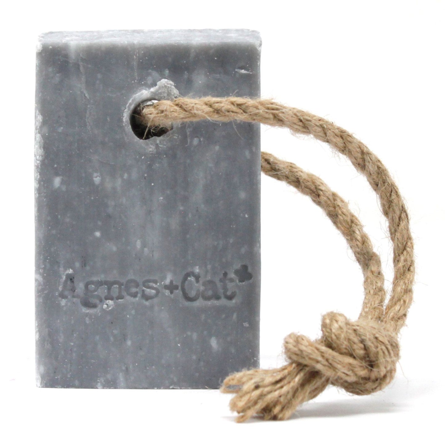 Large rectangular bar soap with a rustic hanging rope featuring embossed text on a neutral background.