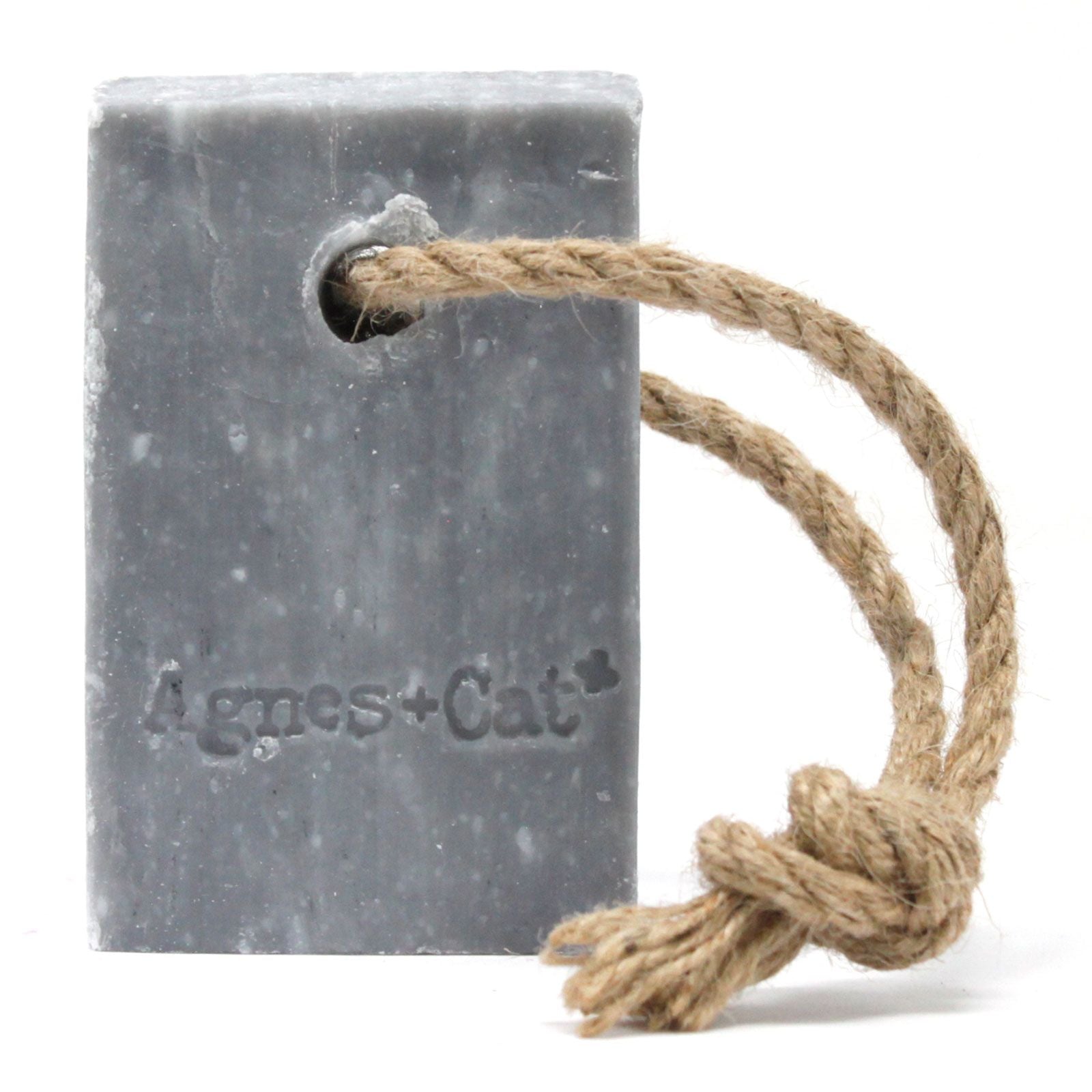 Large rectangular bar soap with a rustic hanging rope featuring embossed text on a neutral background.