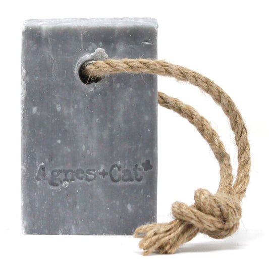 Large rectangular bar soap with a rustic hanging rope featuring embossed text on a neutral background.